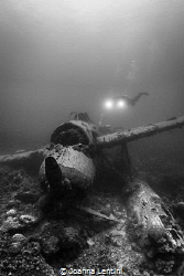 A diver exploring a WWII JAKE Sea Plane in Palau. by Joanna Lentini 